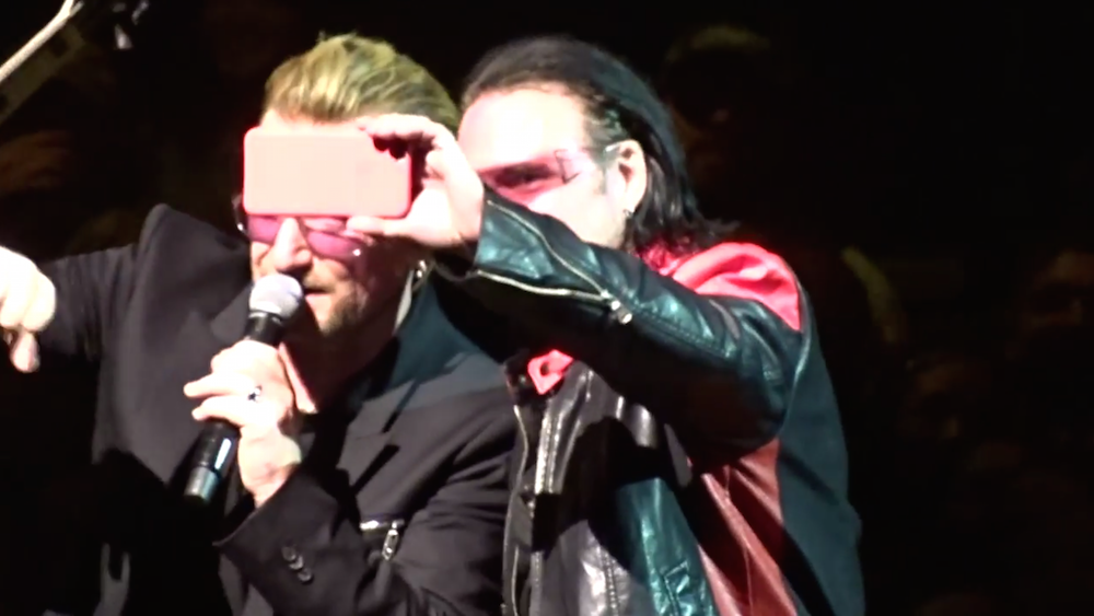 Bono Impersonator Gets To Sing Onstage With U2 And Won't Put His iPhone Down