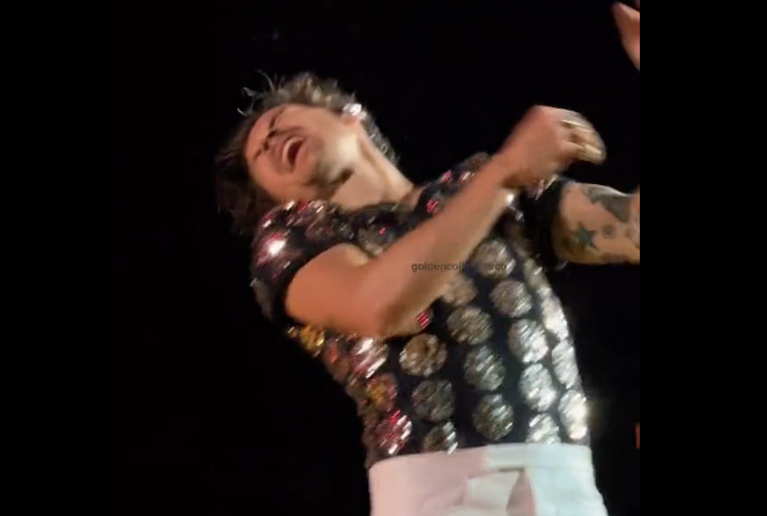 Harry Styles gets a skittle in the eye